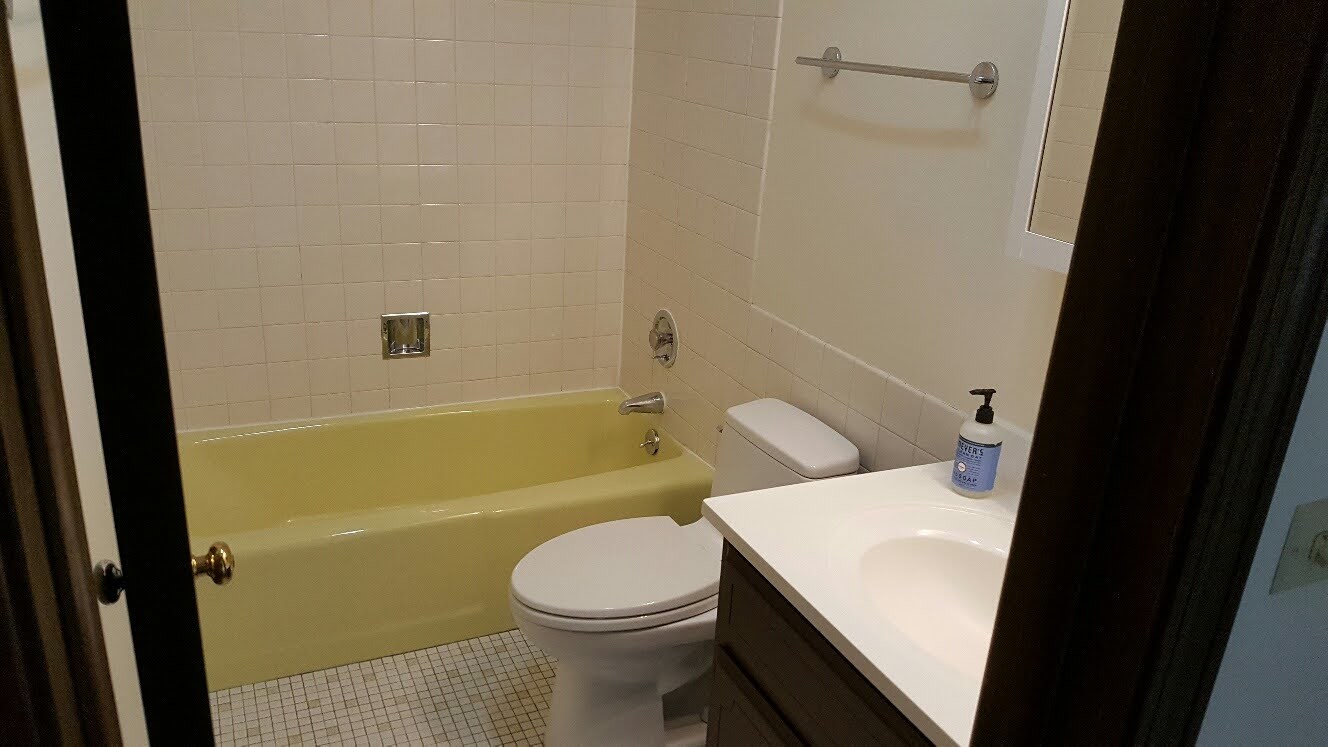 200 Thames Parkway, Unit 2J Park Ridge, IL 60068 - Photo 11 of 21 a white toilet sitting next to a bath tub
