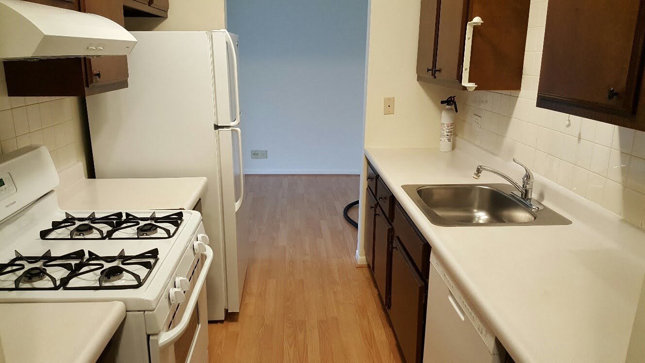 200 Thames Parkway, Unit 2J Park Ridge, IL 60068 - Photo 6 of 21 a kitchen with a sink a stove and refrigerator