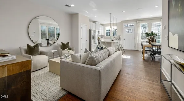 a living room with furniture and a mirror