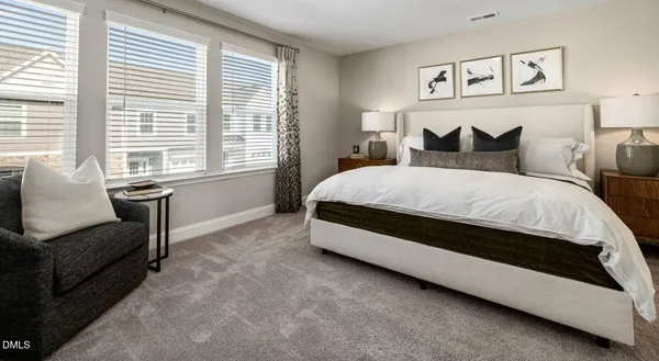 a bedroom with a bed and a couch