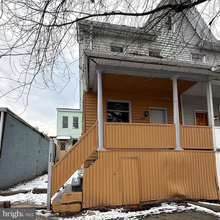a view of a house with wooden fence