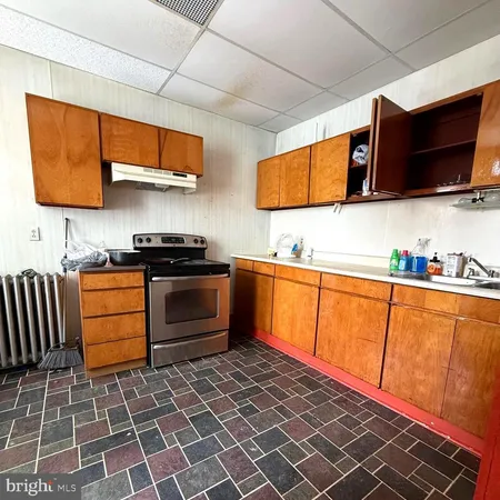 a kitchen with stainless steel appliances a stove a microwave and wooden cabinets