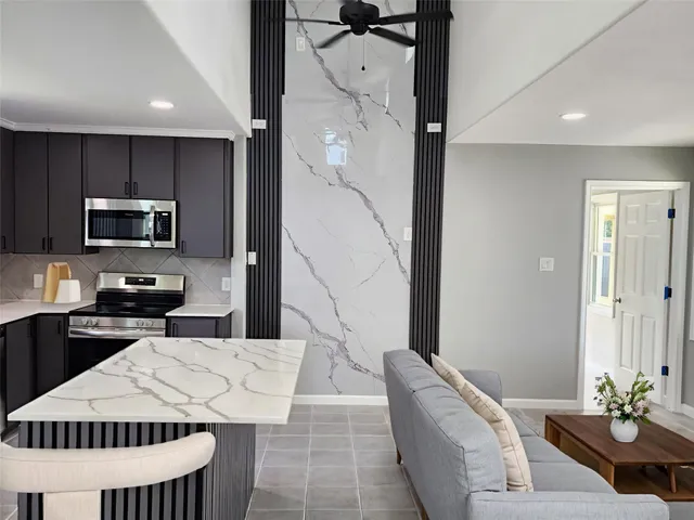 a kitchen with a sink refrigerator and microwave