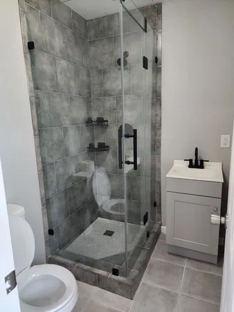 a bathroom with a toilet and a shower