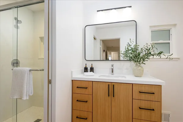 a bathroom with a sink vanity and a mirror