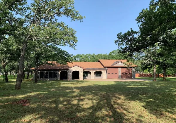 a view of a white house with a yard