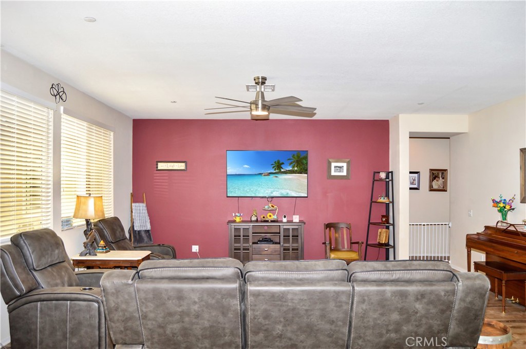 166 Fox Lane Calimesa, CA 92320 - Photo 12 of 76 Spacious Great-Room-Style Living Room with Fabulous Flooring, Ceiling Fan, and Backyard Views (TV screen is simulated)