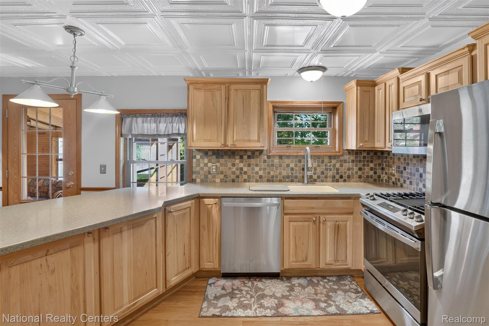 127 West Albain Road Petersburg, MI 49270 - Photo 25 of 61 Kitchen featuring light wood cabinetry, stone-look countertops, and stainless steel appliances