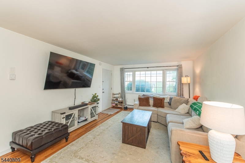 206 Main Street, Unit 42A Millburn, NJ 07041 - Photo 12 of 21 a living room with furniture and a flat screen tv