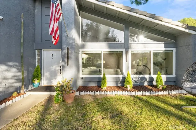 a living room with furniture chandelier and a large window