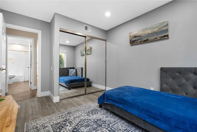 a bedroom with a large bed and a dresser