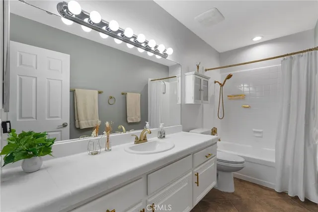 a bedroom with a large bed and a painting on the wall