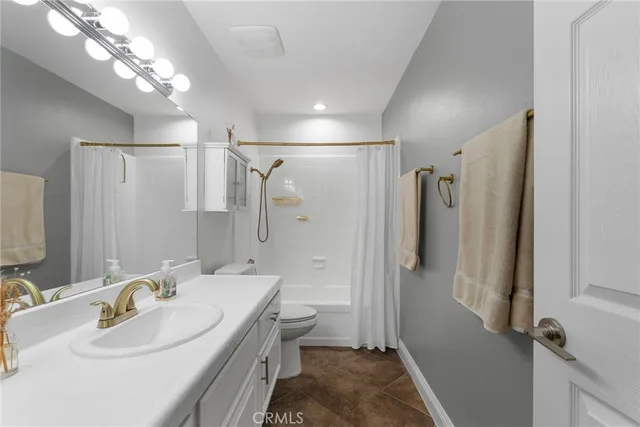 a bedroom with a large bed and a couch