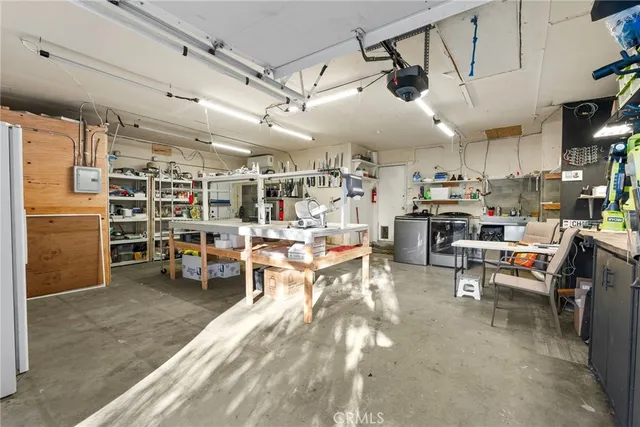 an aerial view of a house with garden space and car parked