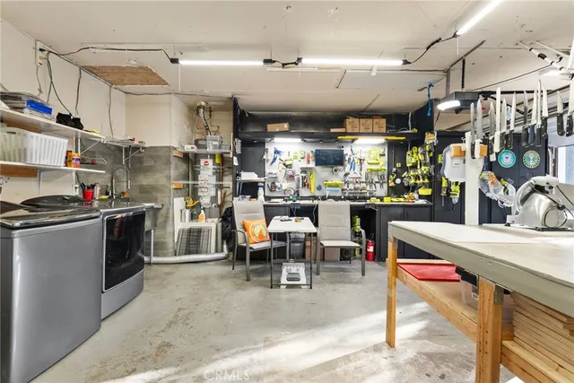 an aerial view of a house with pool garden and a yard