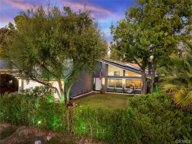 a view of a house with a yard and sitting area