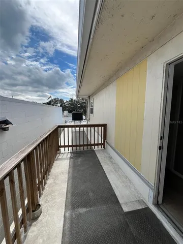 a view of balcony with wooden floor