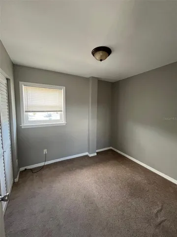 an empty room with a empty space and windows