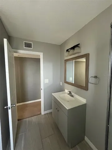 a bathroom with a sink a mirror and shower