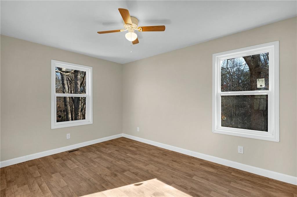 78 Ridgeback Road Talking Rock, GA 30175 - Photo 17 of 35 an empty room with wooden floor and windows