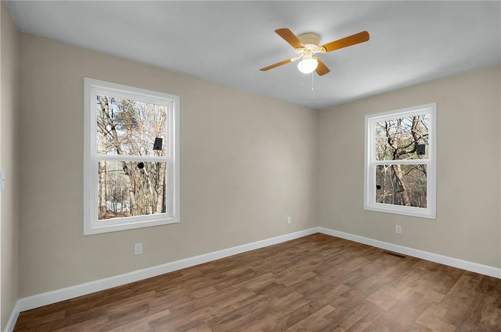 78 Ridgeback Road Talking Rock, GA 30175 - Photo 21 of 35 a view of an empty room with wooden floor and a window