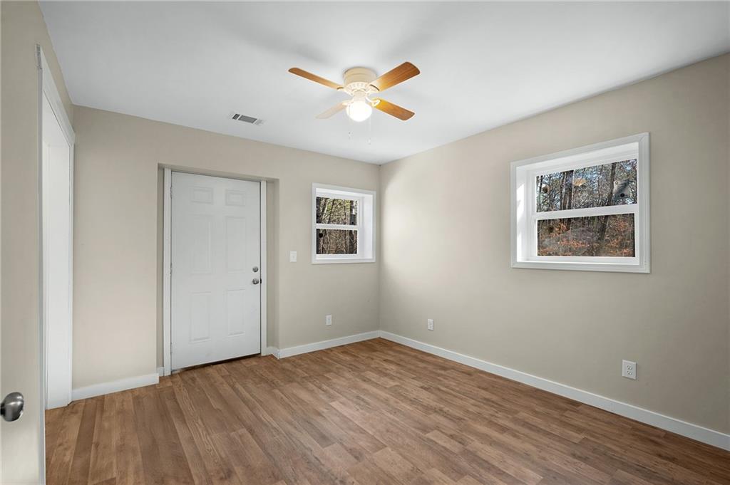 78 Ridgeback Road Talking Rock, GA 30175 - Photo 24 of 41 a view of an empty room with wooden floor and a ceiling fan