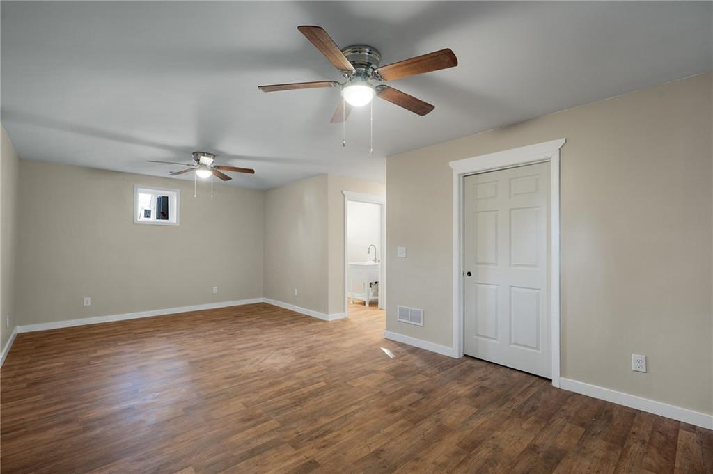 78 Ridgeback Road Talking Rock, GA 30175 - Photo 29 of 35 an empty room with wooden floor chandelier fan and windows