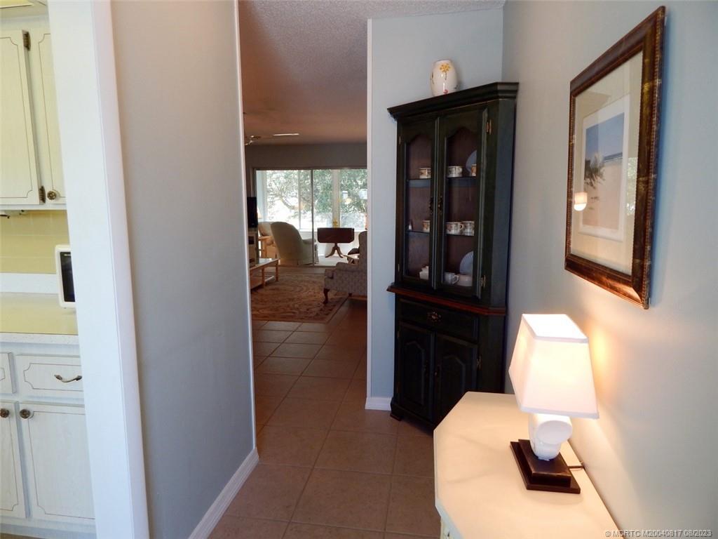 2950 Southeast Ocean Boulevard, Unit 55 Stuart, FL 34996 - Photo 1 of 24 a hallway with a view of living room and wooden floor