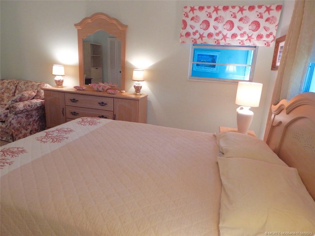 2950 Southeast Ocean Boulevard, Unit 55 Stuart, FL 34996 - Photo 13 of 24 a bedroom with a bed and a dresser
