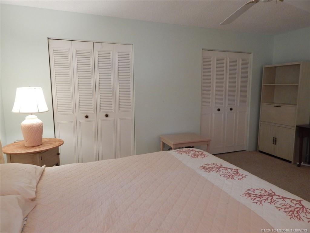 2950 Southeast Ocean Boulevard, Unit 55 Stuart, FL 34996 - Photo 16 of 24 a bedroom with a bed and a lamp