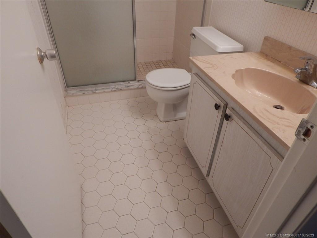 2950 Southeast Ocean Boulevard, Unit 55 Stuart, FL 34996 - Photo 18 of 24 a bathroom with a sink and a toilet