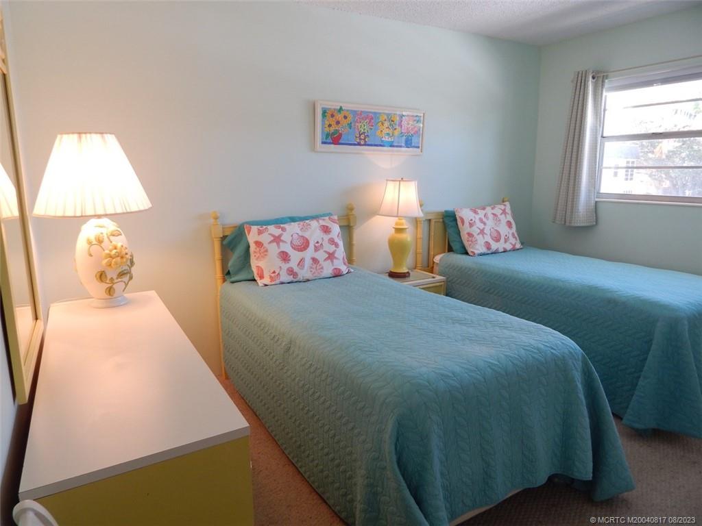 2950 Southeast Ocean Boulevard, Unit 55 Stuart, FL 34996 - Photo 20 of 24 a bedroom with a bed and a window