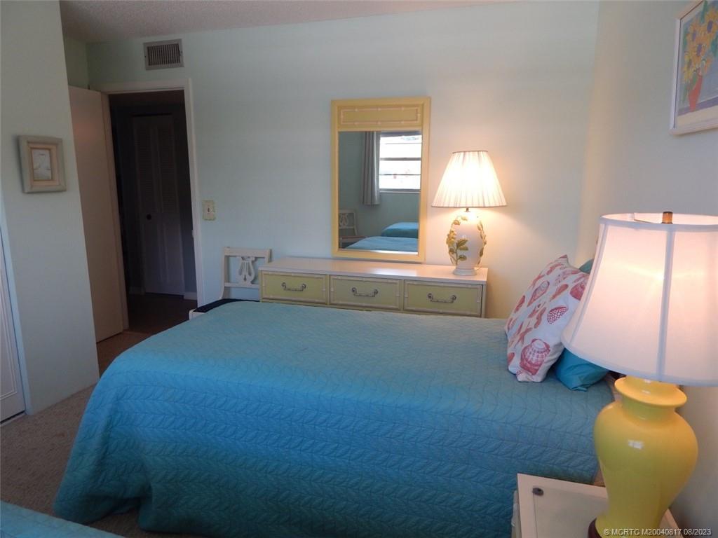 2950 Southeast Ocean Boulevard, Unit 55 Stuart, FL 34996 - Photo 22 of 24 a bedroom with a bed and a window