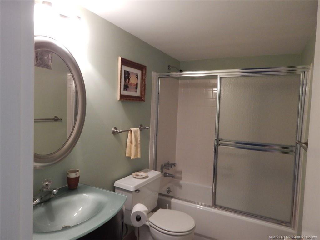 2950 Southeast Ocean Boulevard, Unit 55 Stuart, FL 34996 - Photo 23 of 24 a bathroom with a sink toilet and shower
