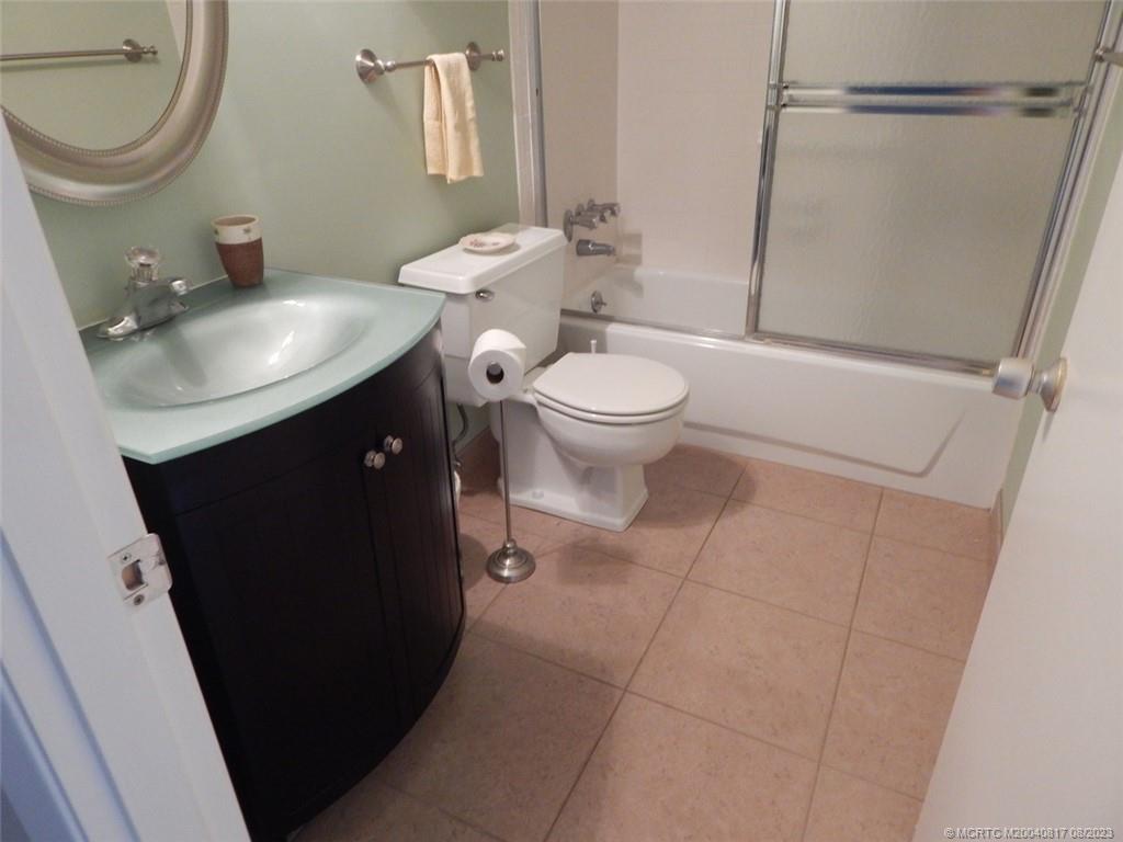 2950 Southeast Ocean Boulevard, Unit 55 Stuart, FL 34996 - Photo 24 of 24 a bathroom with a sink a toilet and a mirror