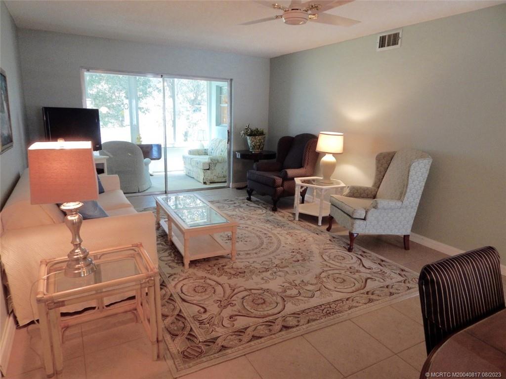 2950 Southeast Ocean Boulevard, Unit 55 Stuart, FL 34996 - Photo 6 of 24 a living room with furniture and a flat screen tv