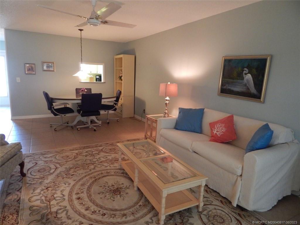 2950 Southeast Ocean Boulevard, Unit 55 Stuart, FL 34996 - Photo 7 of 24 a living room with furniture a dining table and a window