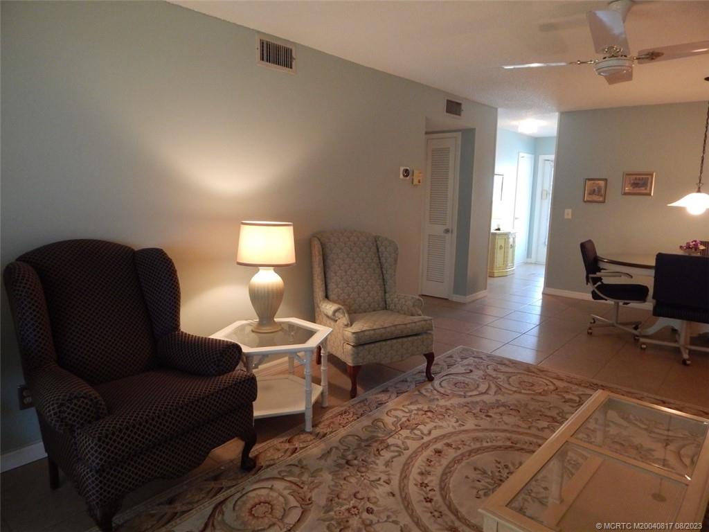 2950 Southeast Ocean Boulevard, Unit 55 Stuart, FL 34996 - Photo 8 of 24 a living room with furniture and wooden floor