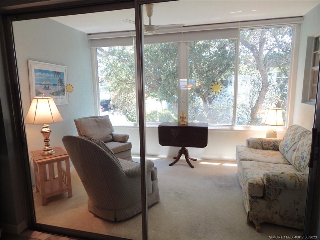 2950 Southeast Ocean Boulevard, Unit 55 Stuart, FL 34996 - Photo 9 of 24 a living room with furniture and a window