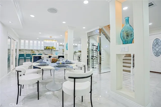 a living room with lots of furniture and a chandelier