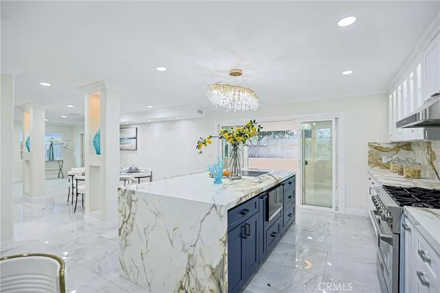 a kitchen with stainless steel appliances granite countertop a sink stove and cabinets