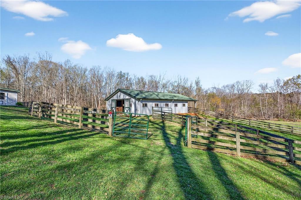 7736 Penns Grove Road Summerfield, NC 27358 - Photo 32 of 50 View of the barn and detached garage from the front porch!