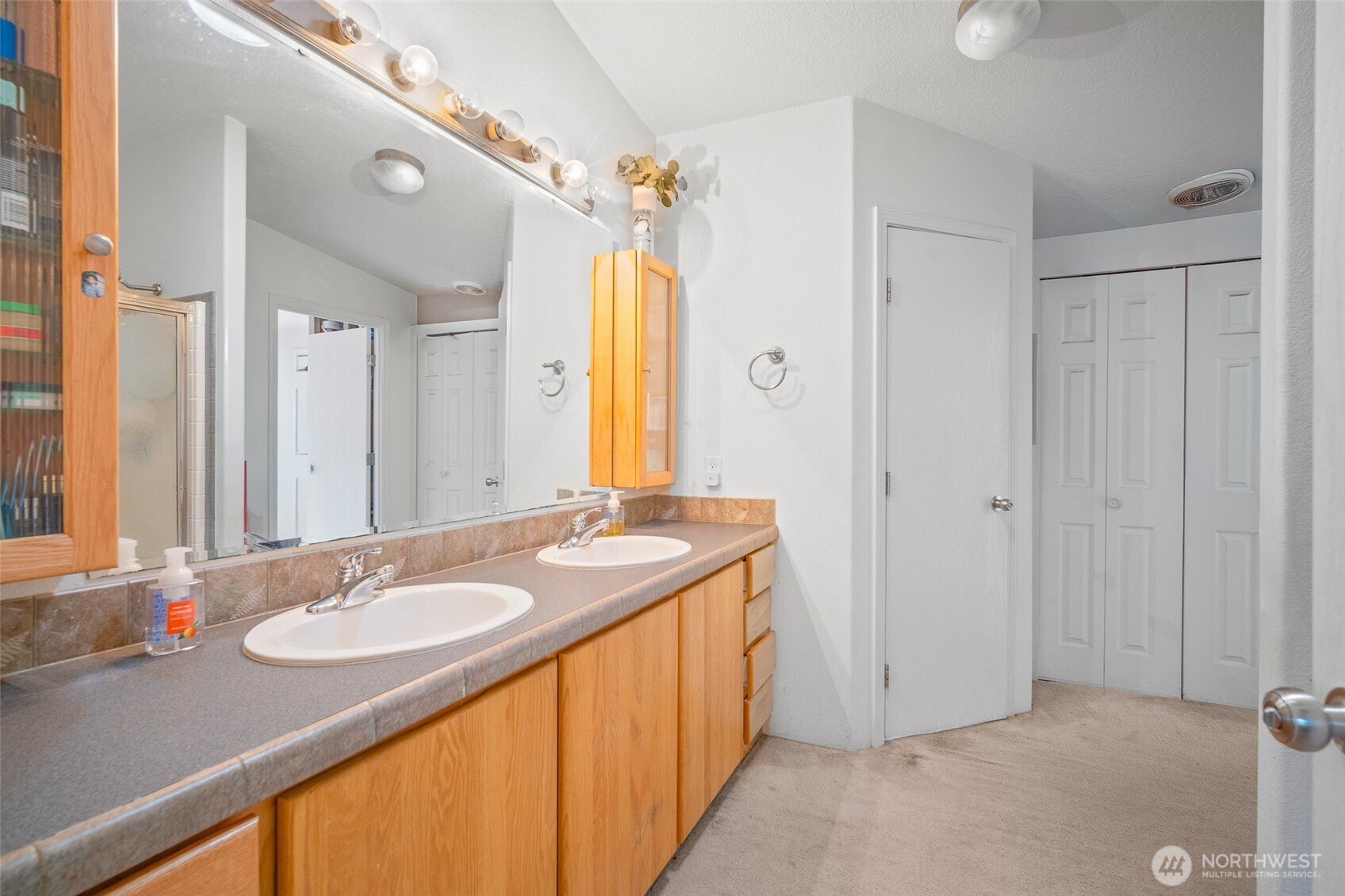 4230 Cody Road Blaine, WA 98230 - Photo 24 of 38 a bathroom with a granite countertop sink and a mirror