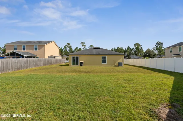 a sign that is sitting in front of flowers