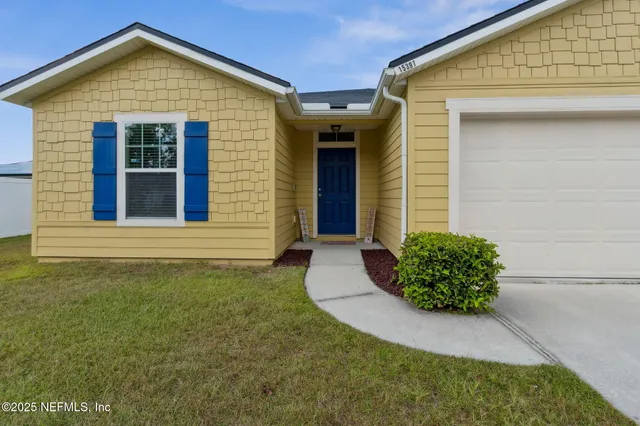 a view of a room with lounge chair and windows