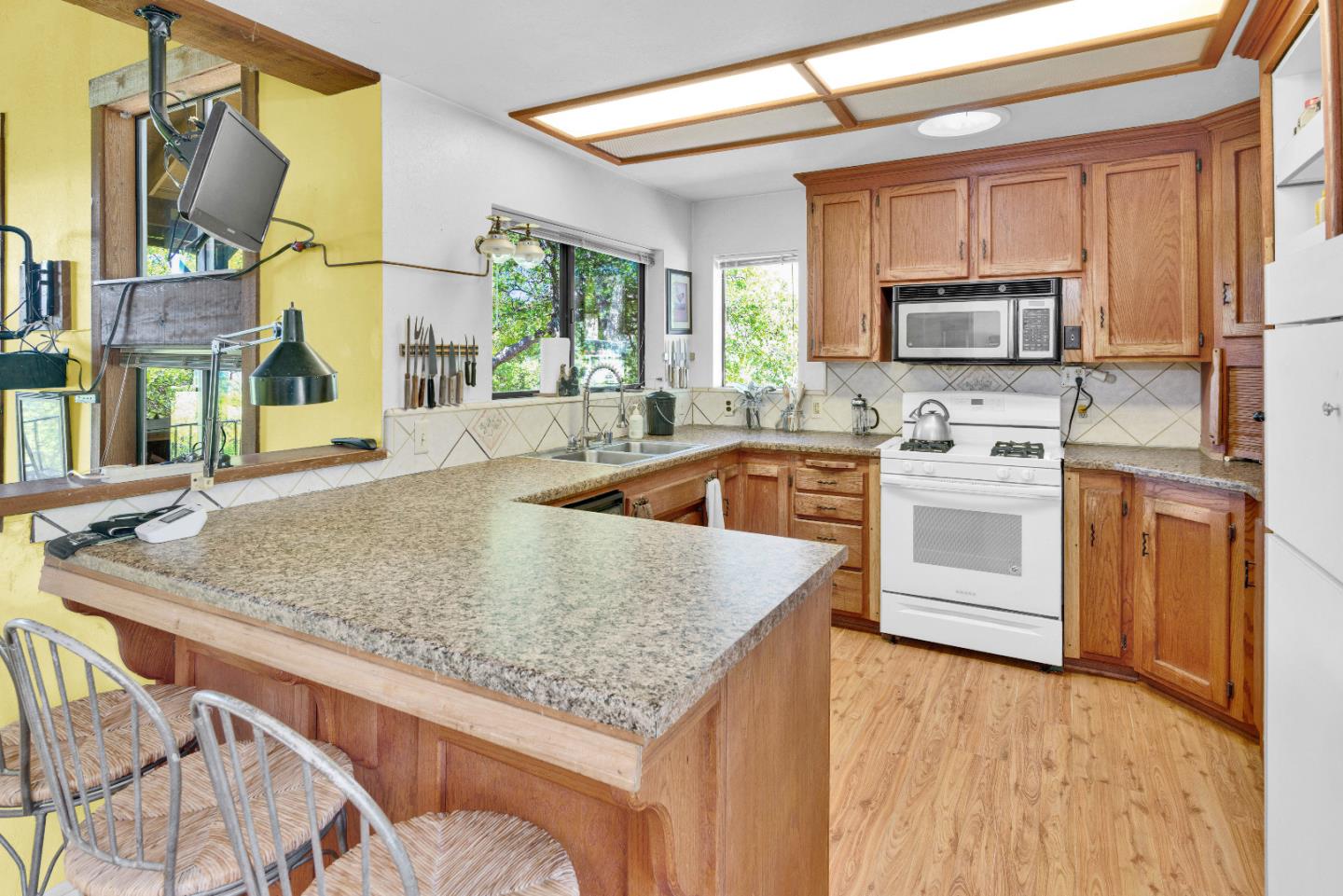38483 Milpitas Road Greenfield, CA 93927 - Photo 14 of 55 a kitchen with stainless steel appliances granite countertop a sink stove and microwave