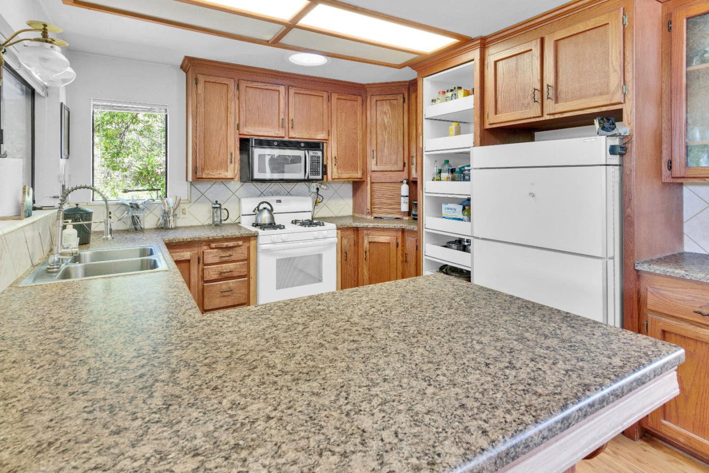 38483 Milpitas Road Greenfield, CA 93927 - Photo 15 of 55 a kitchen with stainless steel appliances granite countertop a sink stove and refrigerator