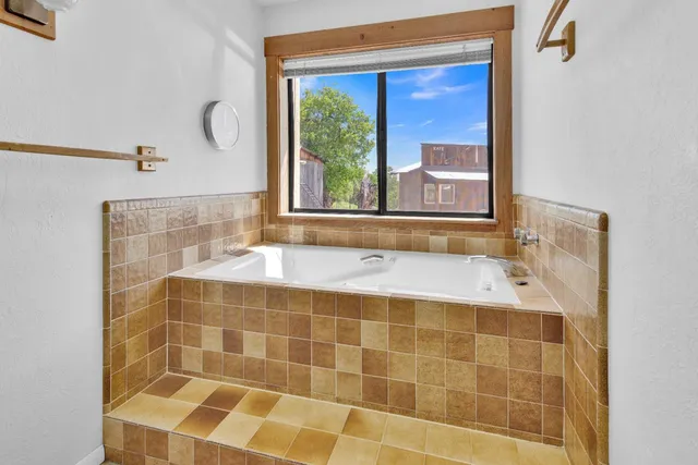 a bathroom with a sink vanity mirror and toilet