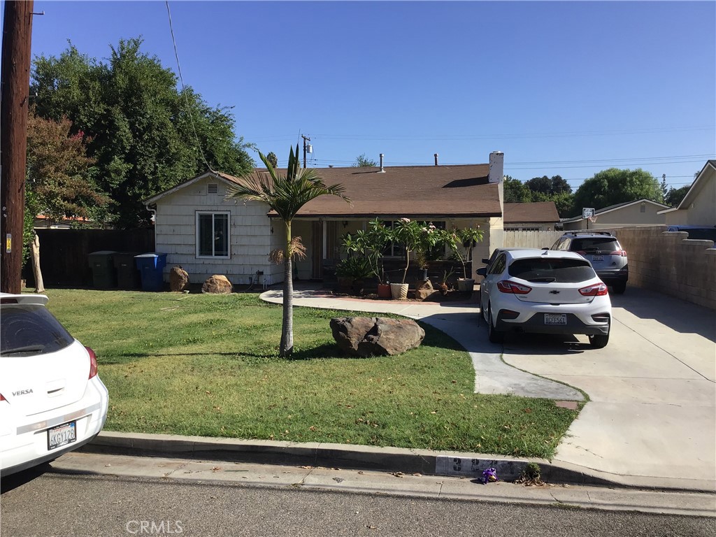 3891 Sherman Drive Riverside, CA 92503 - Photo 1 of 1 a view of a white house in front of a yard with potted plants