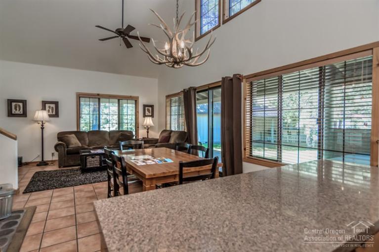 22 Circle 4 Ranch Circle Sunriver, OR 97707 - Photo 14 of 25 a living room with furniture floor to ceiling window and wooden floor